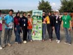 A group of people standing in front of Cadillac Ranch AI-generated content may be incorrect.