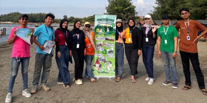 Mahasiswa KKN-T Tematik TPST Kelompok 7 UNDIP Gelar Sosialisasi dan Workshop Daur Ulang Sampah Plastik di Wilayah Pesisir Semarang A group of people standing in front of Cadillac Ranch AI-generated content may be incorrect.