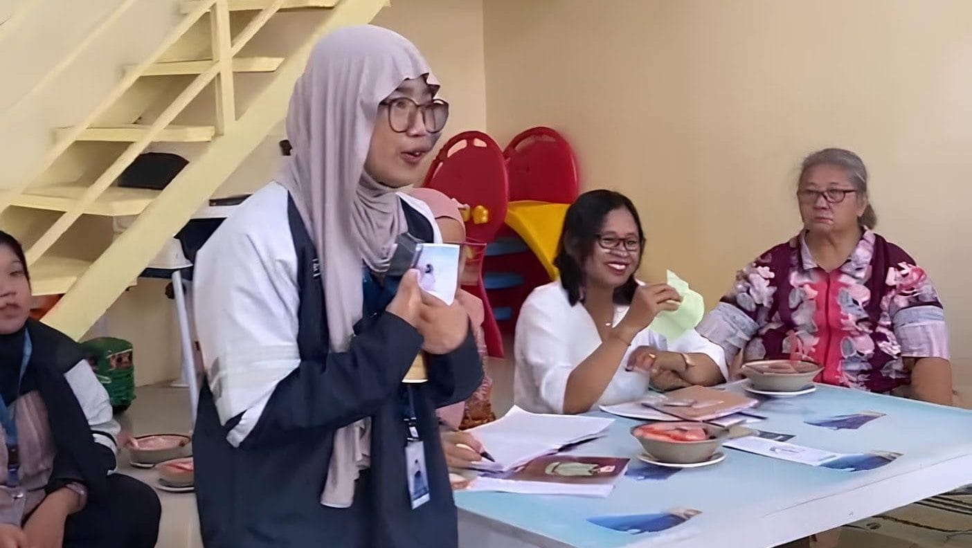 A group of people sitting around a tableDescription automatically generated