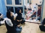 A group of people sitting on the floor AI-generated content may be incorrect.