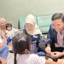 A group of people sitting on the floor AI-generated content may be incorrect.