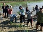 A group of people standing in mud AI-generated content may be incorrect.