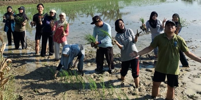 A group of people standing in mud AI-generated content may be incorrect.