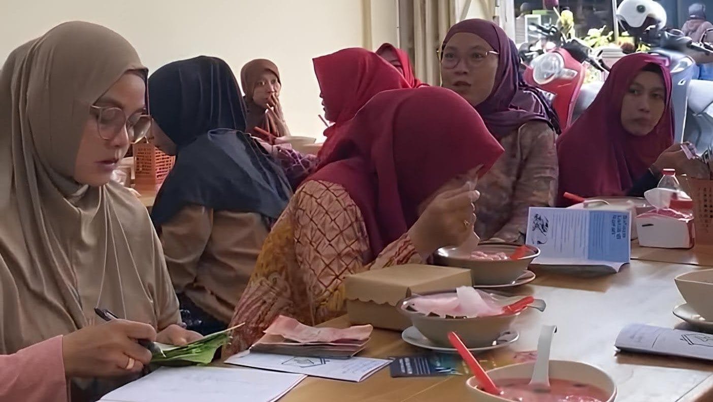 A group of women sitting at a tableDescription automatically generated