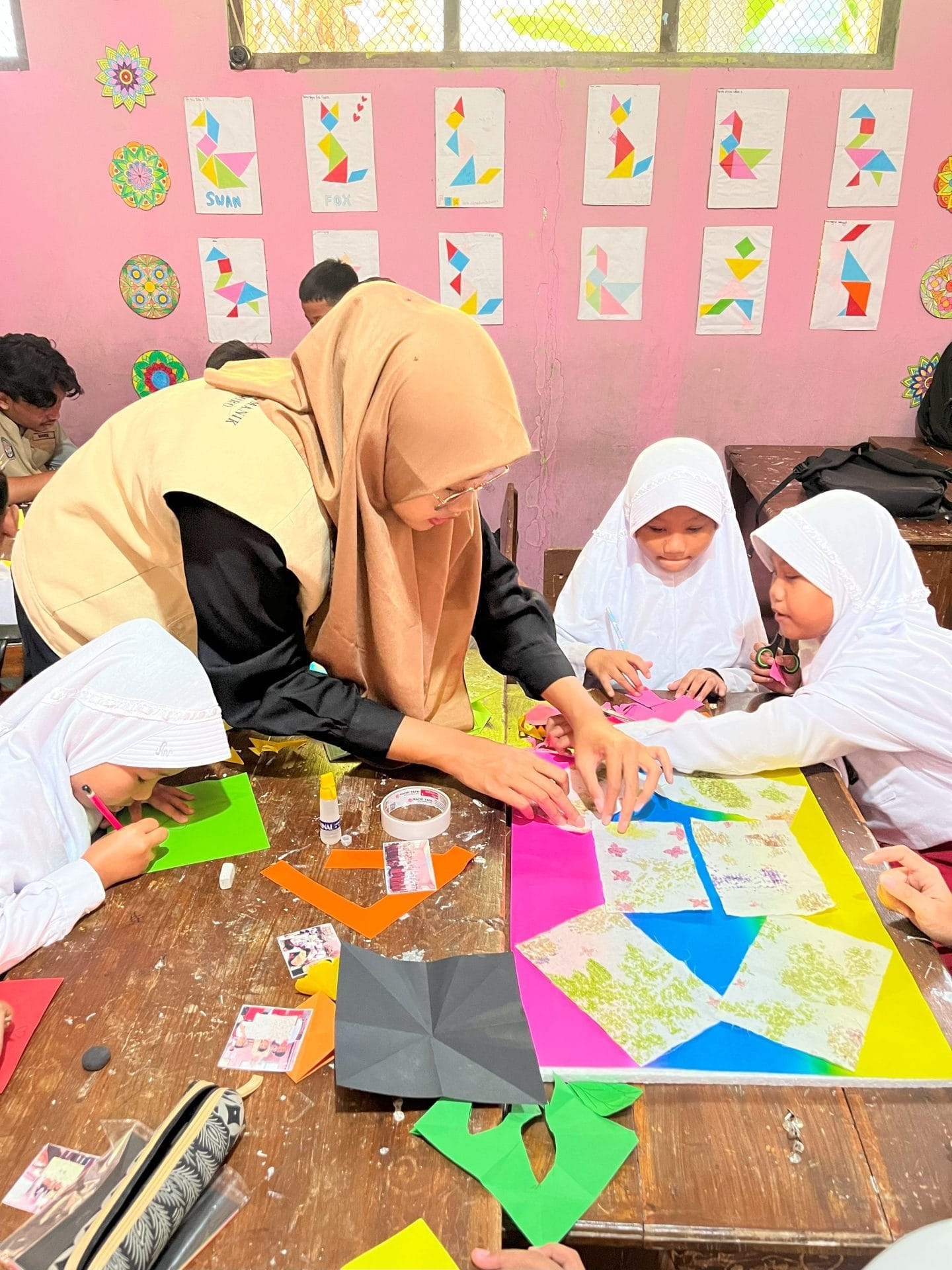 A person and children in a classroomAI-generated content may be incorrect.