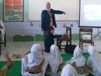 A person teaching a group of children AI-generated content may be incorrect.