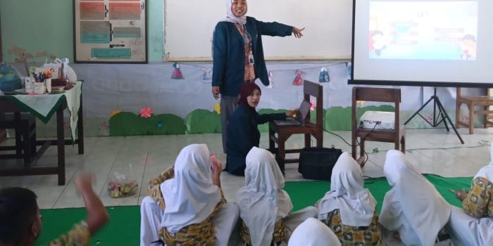 A person teaching a group of children AI-generated content may be incorrect.