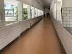 A long hallway with white brick walls AI-generated content may be incorrect.
