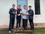 A group of men standing in front of a building Description automatically generated