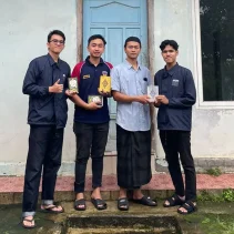 A group of men standing in front of a building Description automatically generated