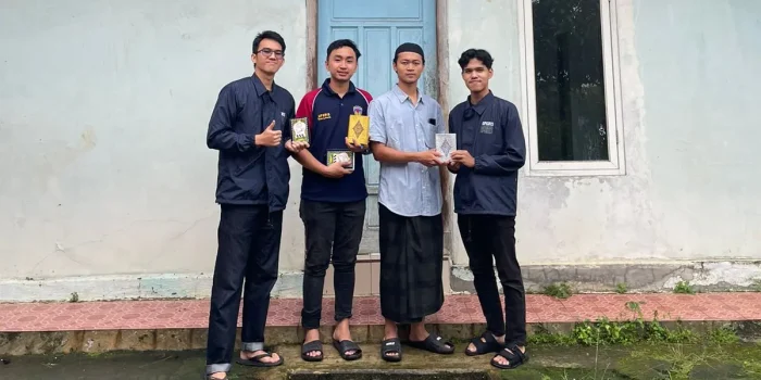 A group of men standing in front of a building Description automatically generated