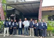 A group of people standing in front of a building Description automatically generated