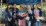 A group of people standing under a canopy Description automatically generated